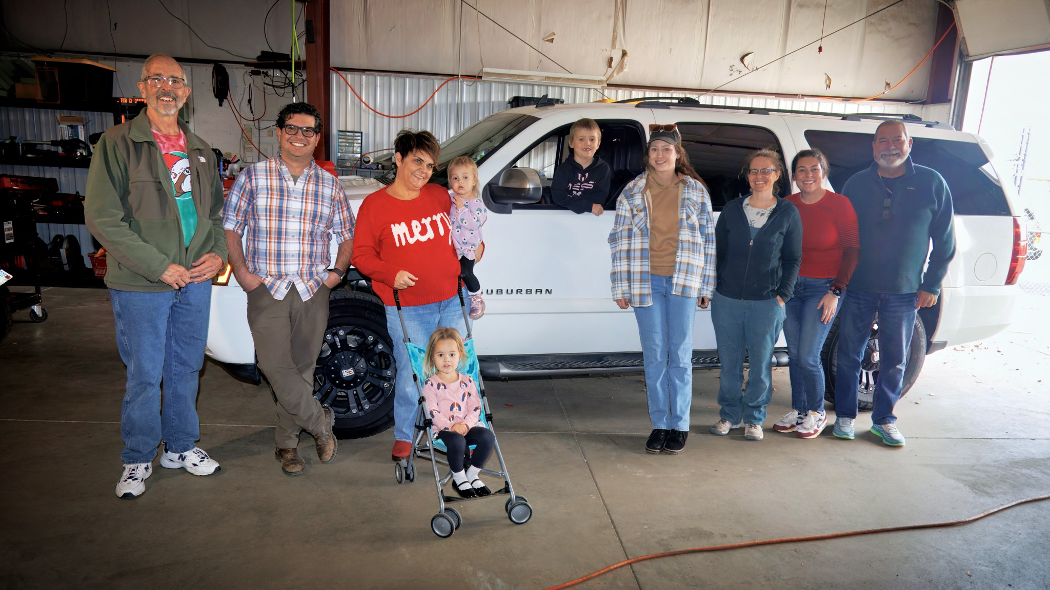 Car show team members and Stitchmasters employees celebrate with our client.