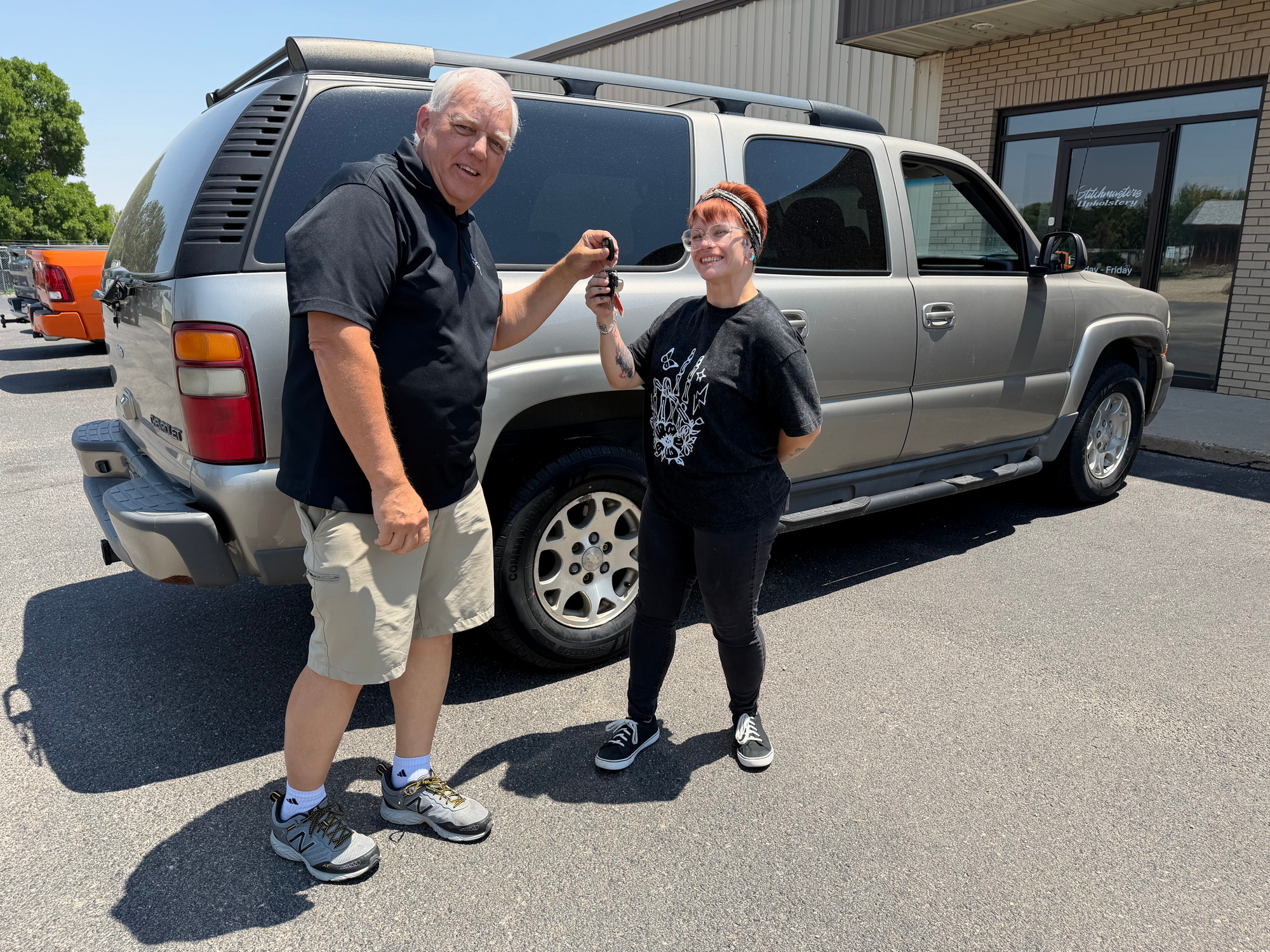 Accepting the keys to her new car!